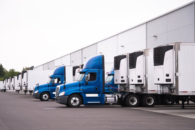 Refrigerated trailers staged at a food distribution dock